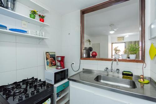 uma cozinha com um lavatório e um fogão em Flat Posto 6 com Piscina - Copacabana no Rio de Janeiro