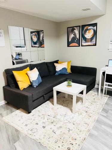 a living room with a black couch and a white table at Oxon Hill Cosy Middle Unit 2 bedroom and 1bath near Gaylord in Oxon Hill