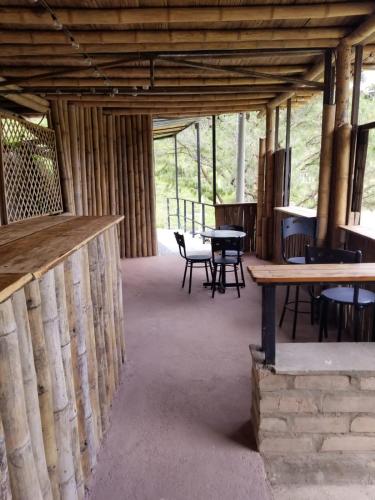 a room with tables and chairs in a building at Springfield Ecoloft- Guatapé in Guatapé