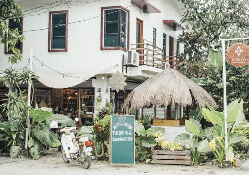 a motorcycle parked in front of a store with a sign at 1-BR flat with kitchen private bath hot and cold shower in General Luna