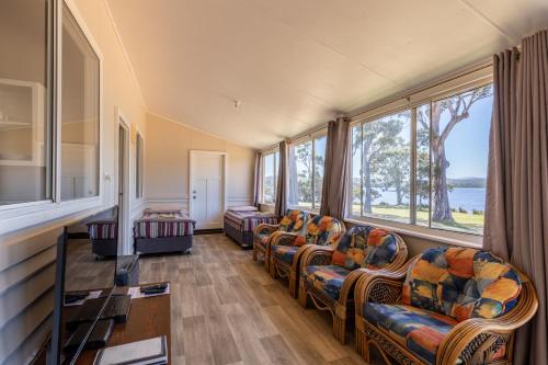 a waiting room with chairs and large windows at Walpole Rest Point Caravan Park in Walpole