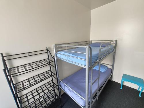 a empty shelf in a room with blue sheets at City Backpackers HQ in Brisbane