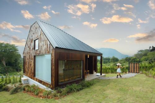 a wooden house with a metal roof at The CAMPIAN in Chiang Mai