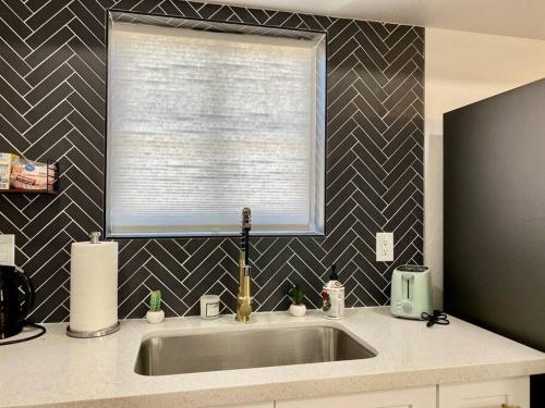 a kitchen sink with a window in a kitchen at Uniquely remodeled historical district home in Phoenix