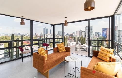 a living room with a view of the city at Casa Insurgentes by Kukun in Mexico City