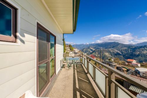 a balcony with a view of the mountains at Water Swing B&B in Renai