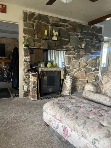 a bedroom with a stone wall with a bed and a fireplace at George's B&B in Lewiston