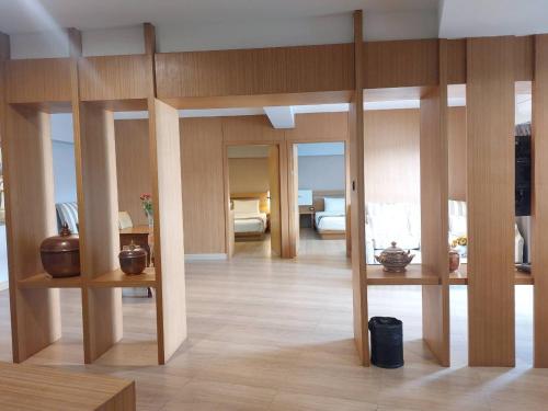 a living room with wooden walls and wooden floors at Buritel Hotel in Buriram