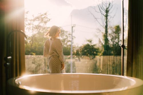 a little girl standing next to a bath tub at The CAMPIAN in Chiang Mai
