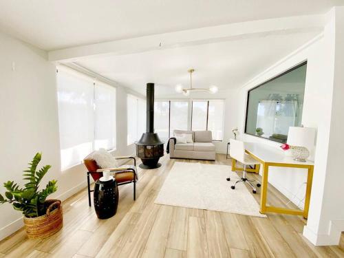 a living room with a desk and a fireplace at Newly remodeled beauty in Phoenix in Phoenix