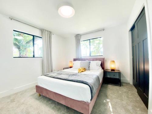 a bedroom with a large bed and two windows at Newly remodeled beauty in Phoenix in Phoenix