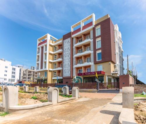 a tall building in front of a building at The Piku's Inn in Digha