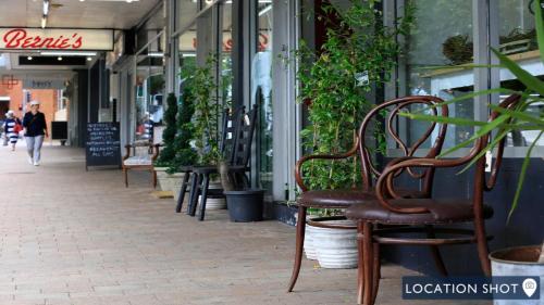 a row of chairs sitting outside of a store at 8 on Clarence in Moss Vale