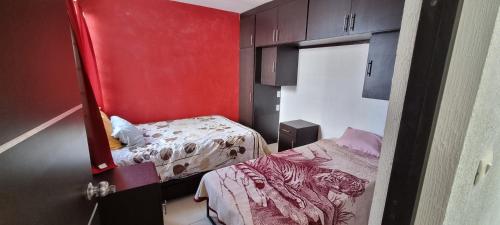 a small room with a bed and a mirror at Casa con alberca Lomas de San Pedro in Querétaro