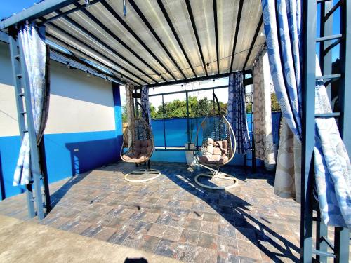 a porch with two chairs and a window at Hidden Palms Inn & Resort Quadruple in San Juan