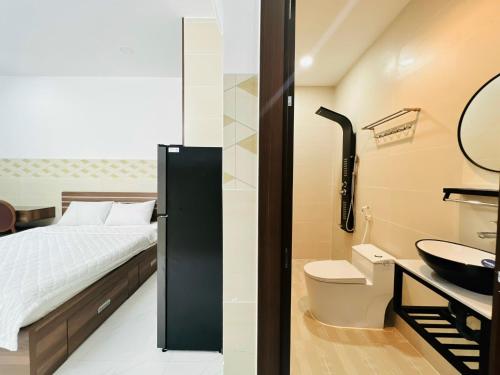 a bathroom with a bed and a sink and a toilet at DREAM HOUSE in Ho Chi Minh City