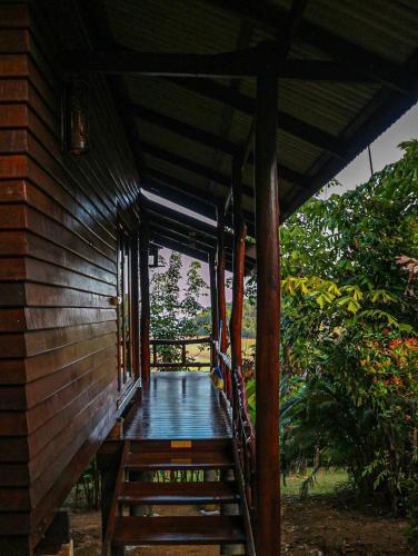 a wooden walkway leading to a porch of a house at Hillhouse - Koh Yao Noi in Ko Yao Noi