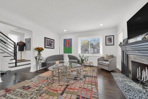 a living room with a couch and a fireplace at Art House Detroit in Detroit