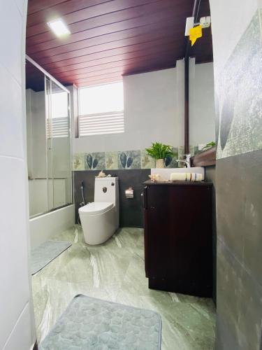 a bathroom with a toilet and a sink at Erin Orr Villa in Wadduwa