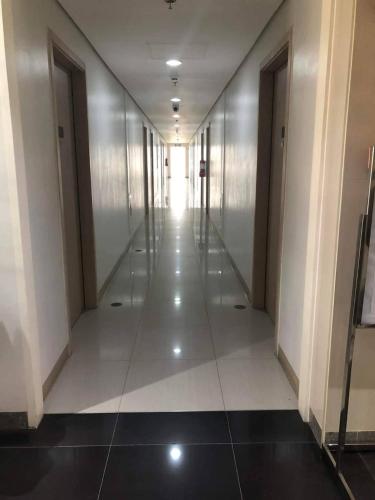 an empty hallway in a building with a light shining on it at SMDC Cheer Residences in Marilao