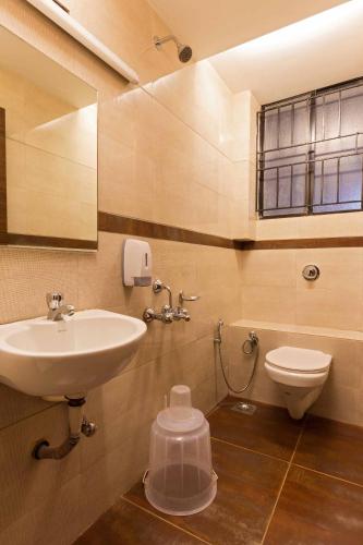 a bathroom with a sink and a toilet at Kanha hotel in Shimla