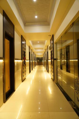 a hallway of a building with a long corridor at Marshall The Grand Hotel in Ahmedabad