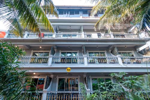 a building with a balcony with people on it at Itsy By Treebo - Adams Beach Resort 350 Mtrs From Baga Beach in Baga