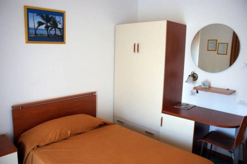 Garlasco的住宿－皮諾酒店，一间卧室配有床、镜子和梳妆台