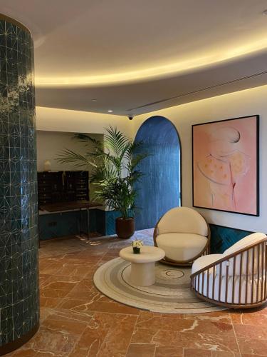 a living room with two chairs and a table at El Fuerte Marbella in Marbella