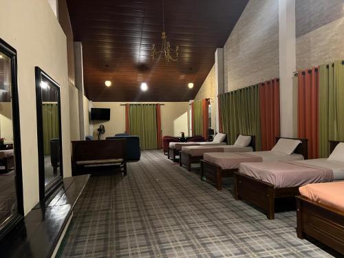 a hospital room with beds and a piano at Hill Cool Hotel & Restaurant in Hatton