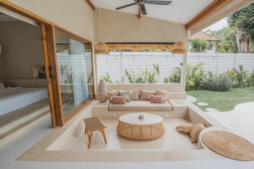 a living room with a couch and a table at Gili Boho Villas - Aesthetic Private Pool Villas in Gili Trawangan