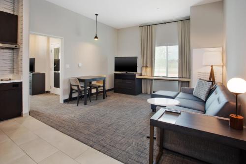 a living room with a couch and a table at Residence Inn By Marriott Wichita Falls in Wichita Falls