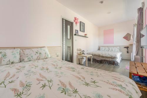 a bedroom with a bed with a floral bedspread at Water Swing B&B in Renai