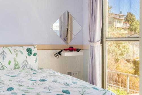 a bedroom with a bed and a window at Water Swing B&B in Renai