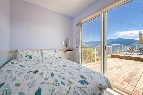 a bedroom with a bed and a large window at Water Swing B&B in Renai