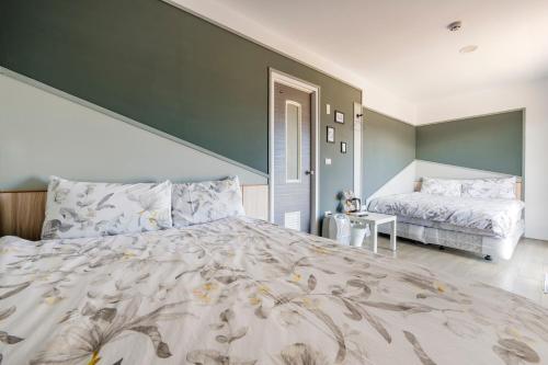 a large bedroom with a large bed and a room with a bed sqor at Water Swing B&B in Renai