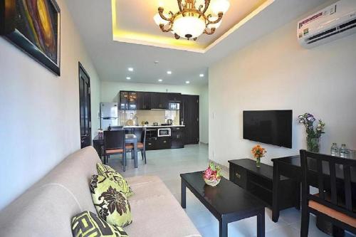 a living room with a couch and a dining room at Kosmos Apart Hotel Phu Quoc - Night market & Walkin to beach in Phú Quốc