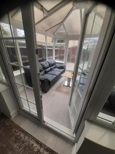 a view of a living room with sliding glass doors at Lovely and Spacious Room with Conservatory in Gravesend
