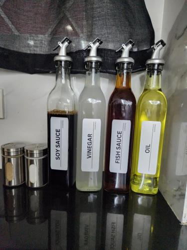 a group of four bottles sitting on a shelf at Kandi Suites 2BR with private Jacuzzi 500 Mbps internet in Angeles