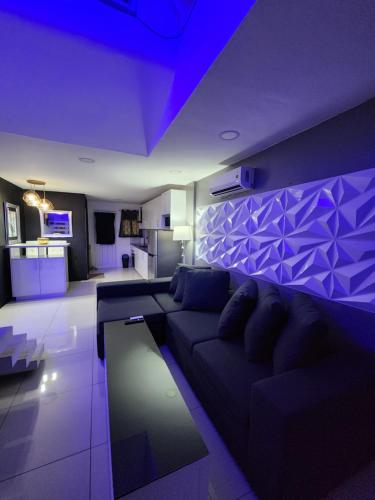 a purple living room with a couch and a kitchen at Kandi Suites 2BR with private Jacuzzi 500 Mbps internet in Angeles