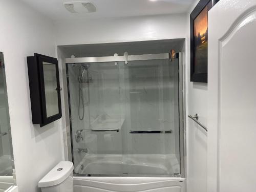 a bathroom with a shower with a glass door at Private room in a House in Mississauga
