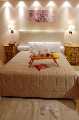 a bedroom with a bed with a tray of fruit on it at Olympic Fashion Hotels in Athens