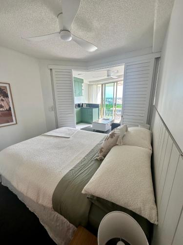a bedroom with a bed and a ceiling fan at 8th Floor Sunny Escape at Landmark Resort in Mooloolaba