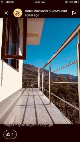 a picture of a balcony with a view of a mountain at Minakshi hotel and restaurant in Mandi