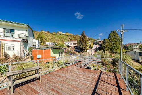 a wooden boardwalk with a bench on top of a city at Water Swing B&B in Renai