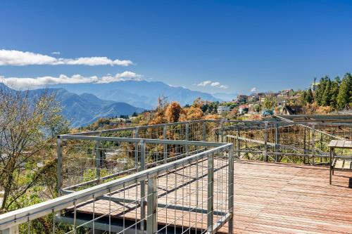 a balcony with a view of the mountains at Water Swing B&B in Renai
