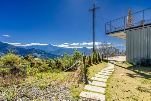 a path leading up a mountain with mountains in the background at Water Swing B&B in Renai