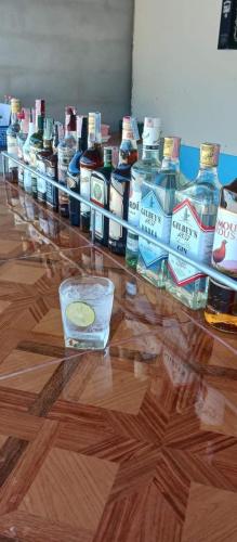 a row of bottles of alcohol on a glass table at River restaurant&room service ครัวริมน้ำ อาหารตามสั่ง&ห้องพักรายวัน in Ban Ranuk