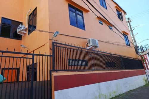 a building with a fence in front of it at Hotel O Homestay Purirano in Lepoleop