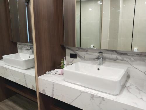 a bathroom with two sinks and a mirror at Moutain & Pool view at Forest khaoyai in Pak Chong